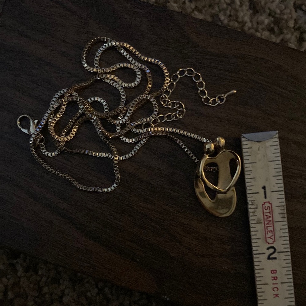 Gold tone people hug necklace
